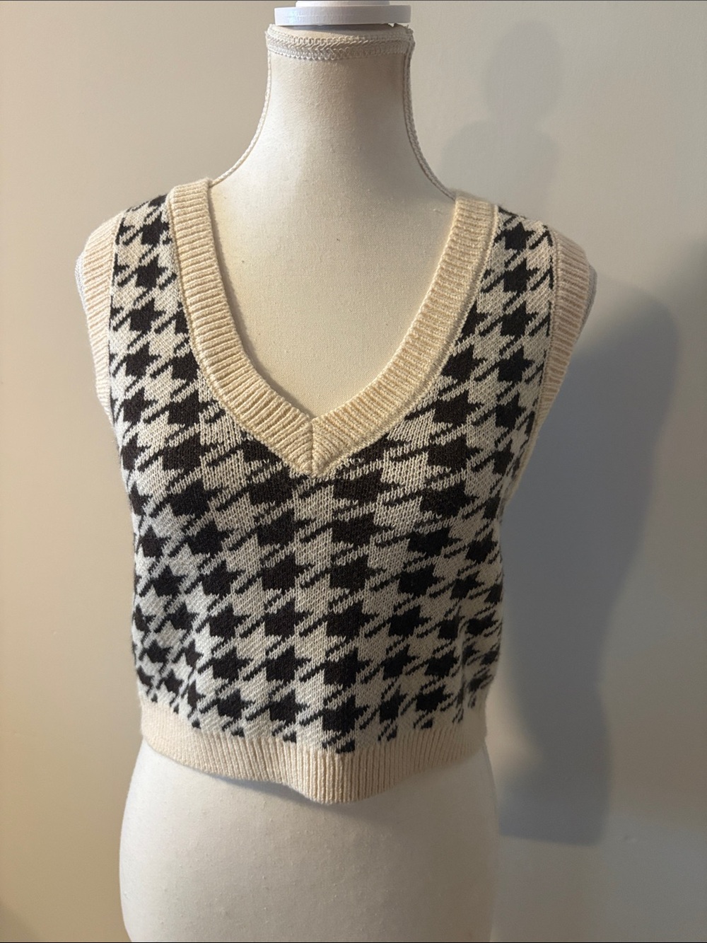 Garage Houndstooth Cropped V-Neck Sweater Vest in Cream and Brown.